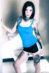 Brunette tattoo model revealing tiny tits and tight ass before masturbating