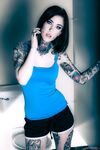 Brunette tattoo model revealing tiny tits and tight ass before masturbating