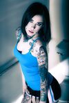 Brunette tattoo model revealing tiny tits and tight ass before masturbating