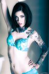 Brunette tattoo model revealing tiny tits and tight ass before masturbating