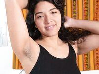 Plump amateur Maria F finger spreads her beaver after getting naked on a couch