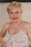 Charming granny Ursula Grande takes her top off and shows natural saggy tits