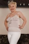 Charming granny Ursula Grande takes her top off and shows natural saggy tits