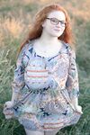 Hot redhead BBW Kaycee looses her huge tits and gets on her knees in a field