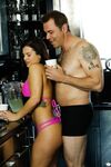 Sexy brunette babe in pink bikini getting horny with her lover in the kitchen