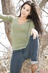 Latina chick Bella Quinn climbs a tree in the park wearing a sweater and jeans