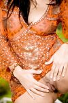 Dark haired babe Sunny Leone toys her landing strip pussy in cowgirl boots