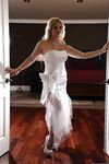 Sexy blonde bride sheds her wedding gown to pose topless in stockings & garter