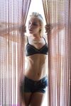 Blonde girl Chloe Toy drinks and smokes while modeling lingerie