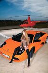 Redhead pornstar in black stockings gets banged on the hood of sports car