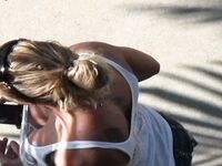Oblivious busty Karmen Jay's big tits captured in downblouse voyeur photos