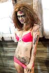 Saucy brunette cosplayer Kleio unveils her zombie tits and pussy