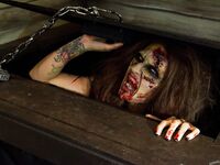 Saucy brunette cosplayer Kleio unveils her zombie tits and pussy