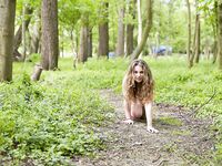 Solo girl Bunny Babe poses in the nude in a farmer's field