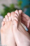 Slender brunette Elly peels her jeans and flexes her sexy toes while naked