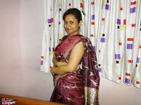 Clothed Indian woman strips to her black bra and underskirt