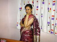 Clothed Indian woman strips to her black bra and underskirt