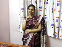 Clothed Indian woman strips to her black bra and underskirt