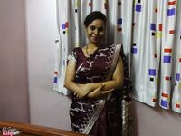 Clothed Indian woman strips to her black bra and underskirt
