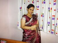 Clothed Indian woman strips to her black bra and underskirt