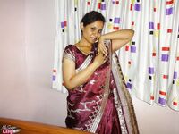 Clothed Indian woman strips to her black bra and underskirt