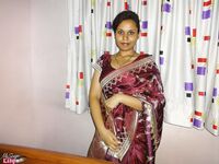 Clothed Indian woman strips to her black bra and underskirt