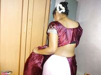 Clothed Indian woman strips to her black bra and underskirt