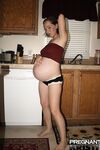 Pregnant amateur removes a tube top before slipping out of sexy panties