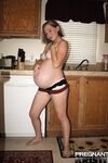 Pregnant amateur removes a tube top before slipping out of sexy panties