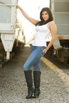 Black-haired bombshell Sunny Leone in white shirts, blue jeans, and high boots