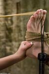 Dark haired Dominatrix Penny Flame butt fucks a rope restrained male in latex