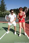 Sexy Penny Flame entices with ass & cleavage in tight dress on a tennis court
