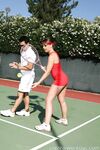 Sexy Penny Flame entices with ass & cleavage in tight dress on a tennis court
