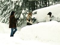 Three big boobed stunners pose braless in their fur coats in the snow