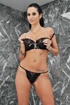 Busty MILF Ava Addams gets rid of her red dress and bra to pose in panties
