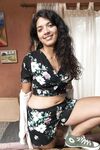 Brunette with a sexy smile Maria F opens her legs wide to show her hairy pussy