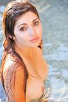 Cute teen shows off her tits at the beach before inserting lipsticks into twat