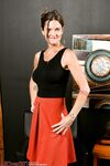 Older lady Cj removes red skirt on her way to posing naked