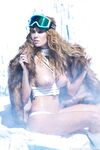 Captivating redhead model Elizabeth Ostrander reveals her big tits on the snow