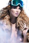 Captivating redhead model Elizabeth Ostrander reveals her big tits on the snow
