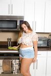Hot plump brunette in booty shorts teasing with her naked ass in the kitchen