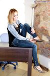 Solo model Valeria removes flat shoes from bare feet while fully clothed