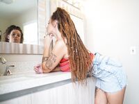 Amateur girl Indica Flowers exposes her tits and ass while in the bathroom