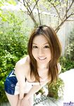 Sexy Japanese girl Tatsumi Yui holds an umbrella while standing naked