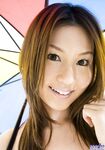 Sexy Japanese girl Tatsumi Yui holds an umbrella while standing naked