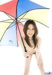 Sexy Japanese girl Tatsumi Yui holds an umbrella while standing naked