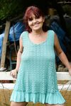 Redhead granny Livia lifts her blue dress up and reveals big natural tits