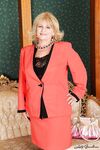 Curvy granny in stockings stripping off her suit and lingerie