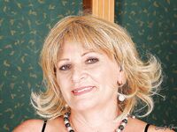 Curvy granny in stockings stripping off her suit and lingerie
