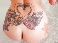 Tattooed solo girl Daniella Mae releasing big tits from bikini in bathroom